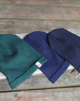 Dark green and navy hats